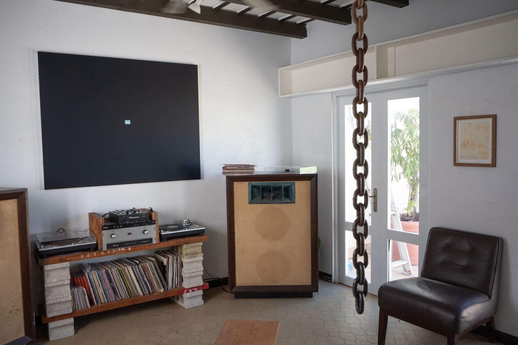 Turntables, mixer and record collection beside a horn speaker